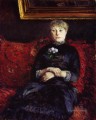 Mujer sentada en un sofá de flores rojas Gustave Caillebotte